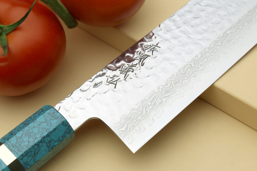 Nakiri vegetable knife close-up: hammered damascus blade and turquoise octagonal handle