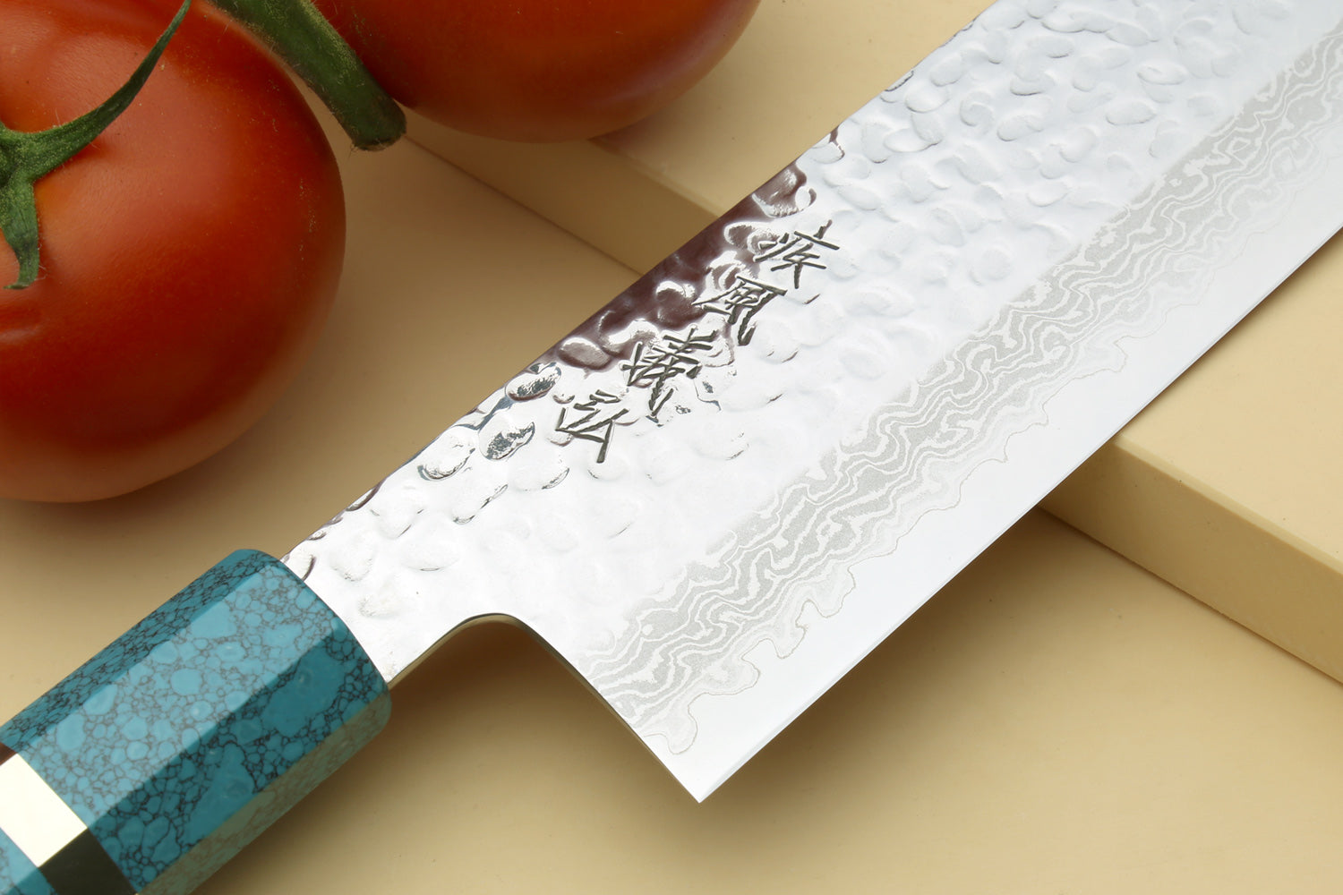 Nakiri vegetable knife close-up: hammered damascus blade and turquoise octagonal handle