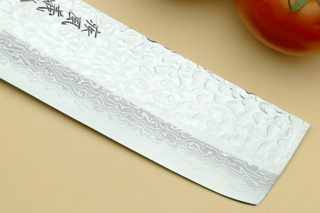 Nakiri vegetable knife blade close-up with hammered damascus pattern