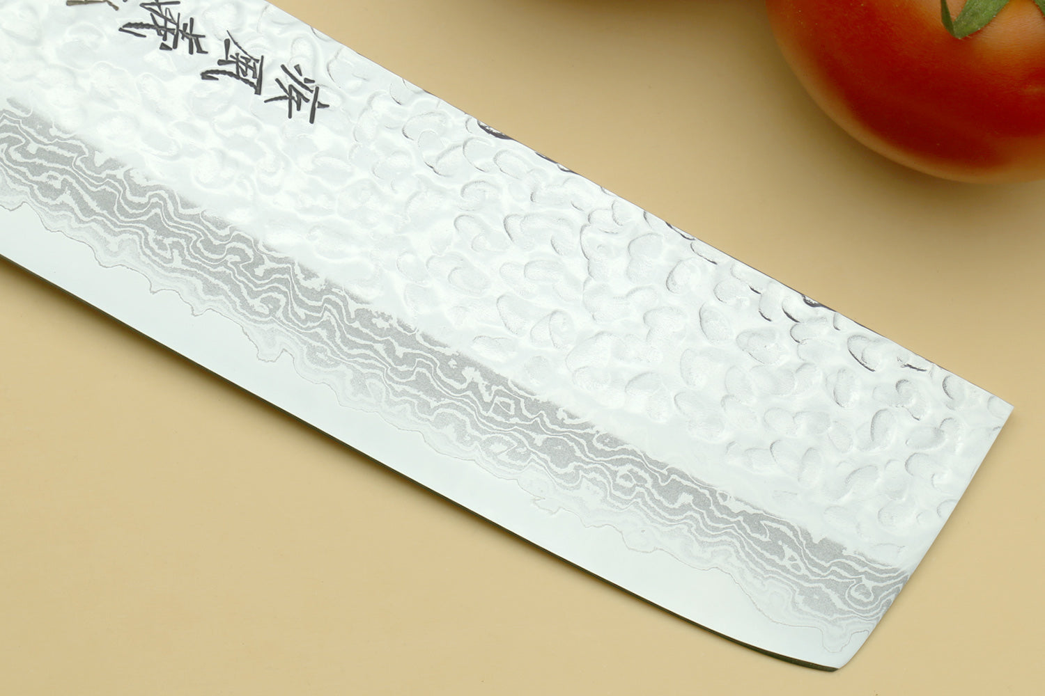 Nakiri vegetable knife blade close-up with hammered damascus pattern