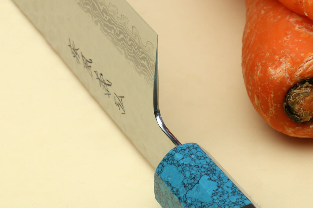 Nakiri vegetable knife detail: damascus blade edge with turquoise octagonal handle