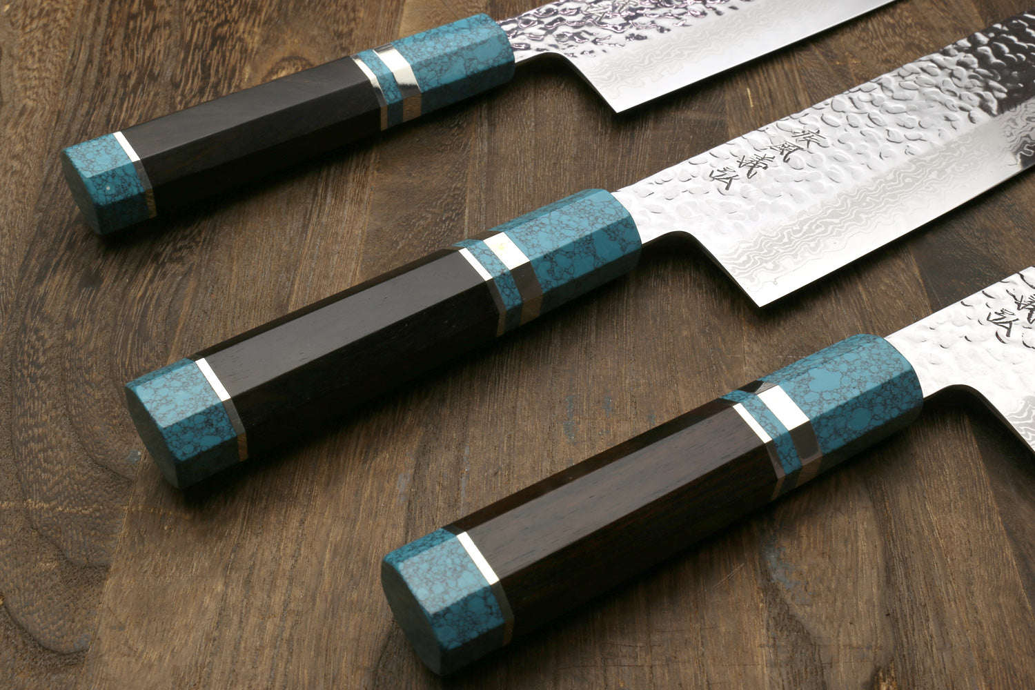 Nakiri vegetable knives displayed: hammered damascus blades with turquoise octagonal handles