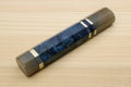 Ocean blue knife handle with horn bolster, striped center wrap, and end cap