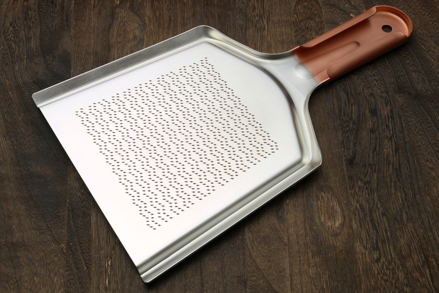 Radish grater with rose copper handle and perforated stainless grating plate