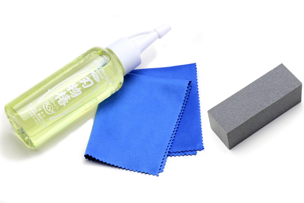 Rust eraser set with two blocks: green oil bottle, blue cloth, gray erasers