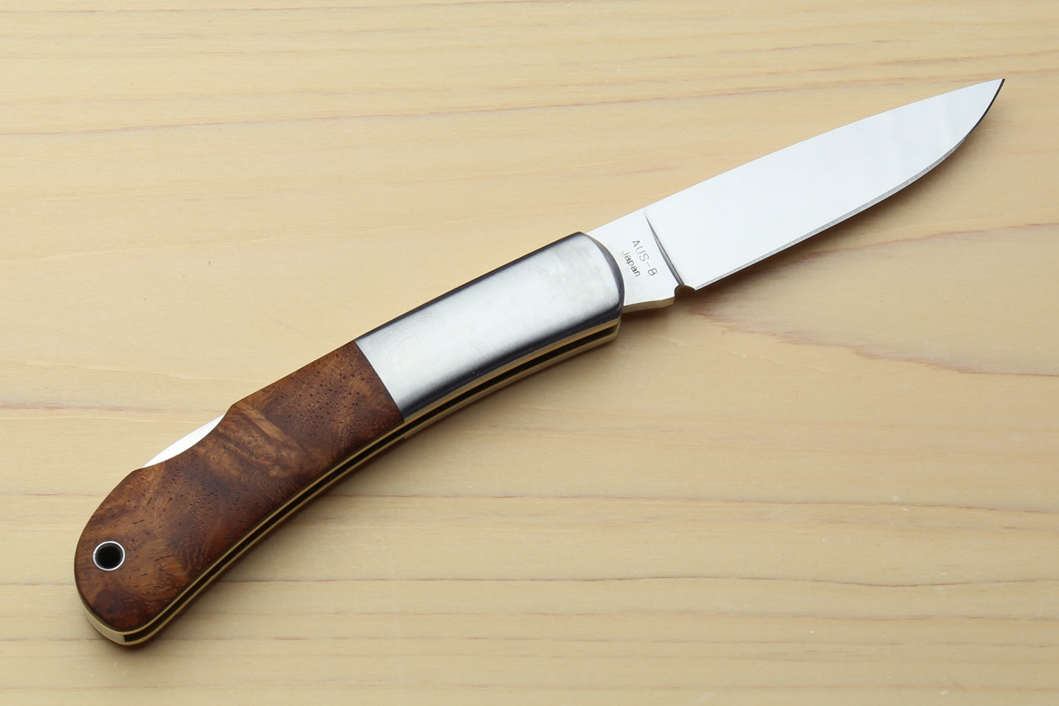 Polished stainless folding pocket knife with brown wood handle, lockback blade