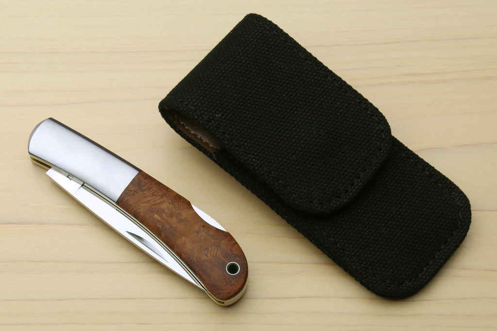 Lockback folding pocket knife with brown wood handle and black fabric carrying case