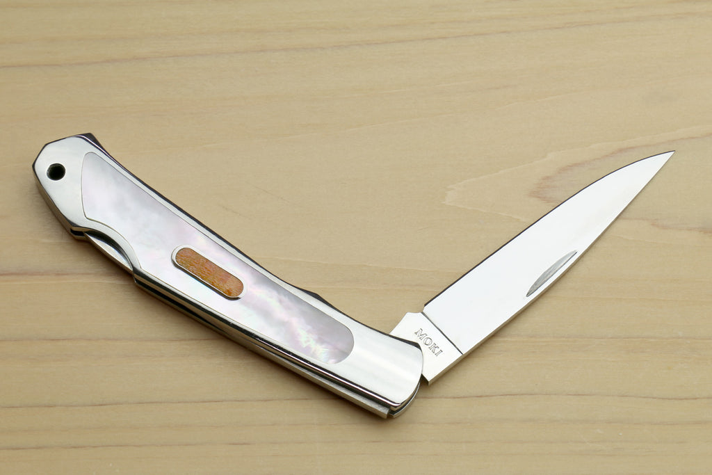 Polished stainless steel lockback folding pocket knife with purple abalone-style inlay