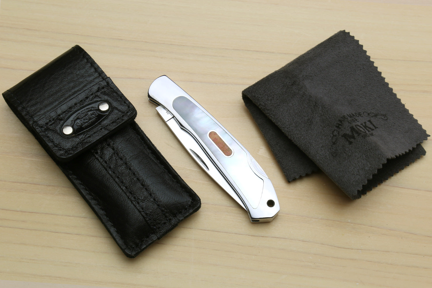 Polished stainless lockback folding pocket knife with leather sheath and cloth