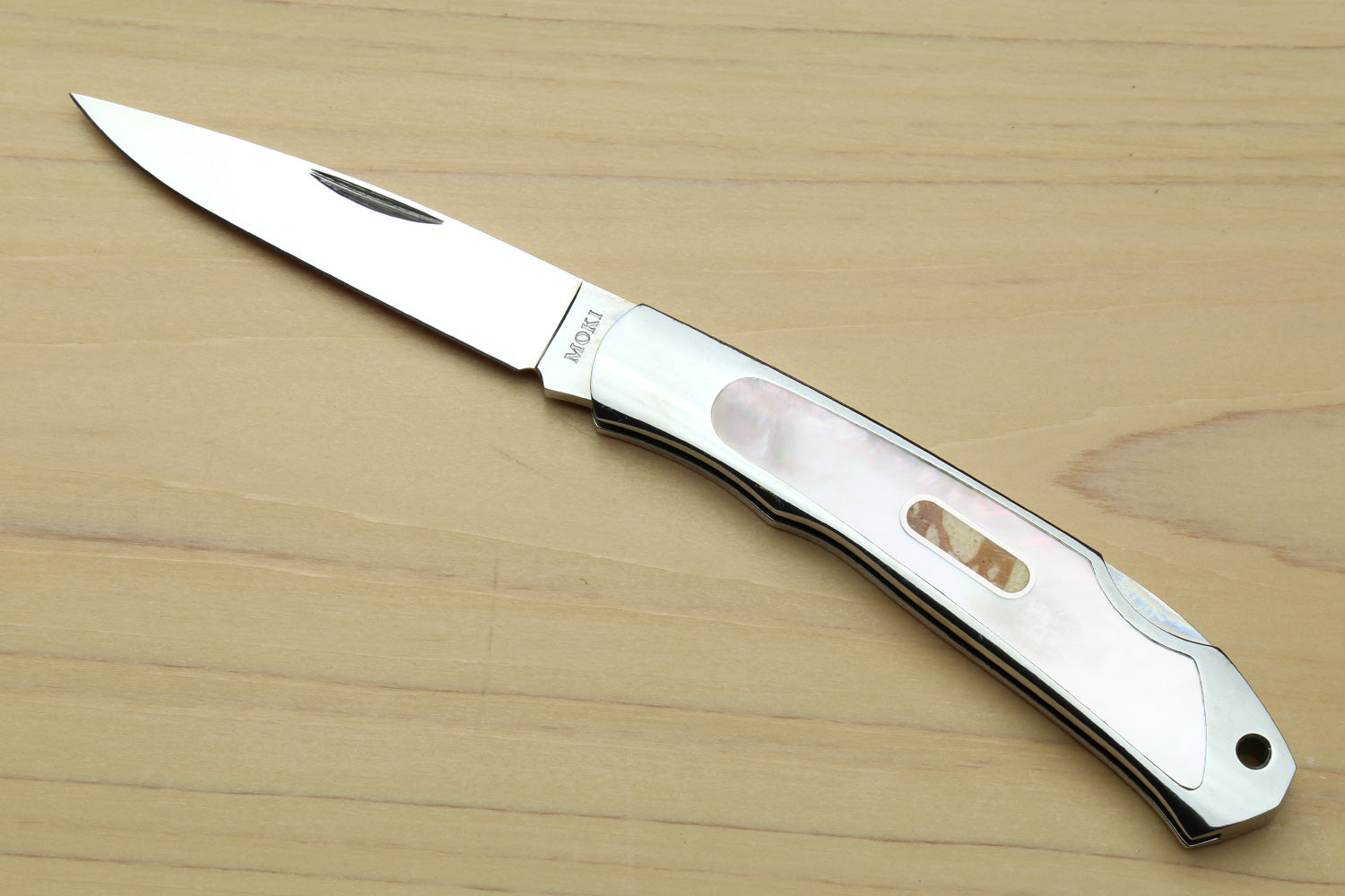 Stainless steel lockback folding pocket knife with white handle and abalone inlay