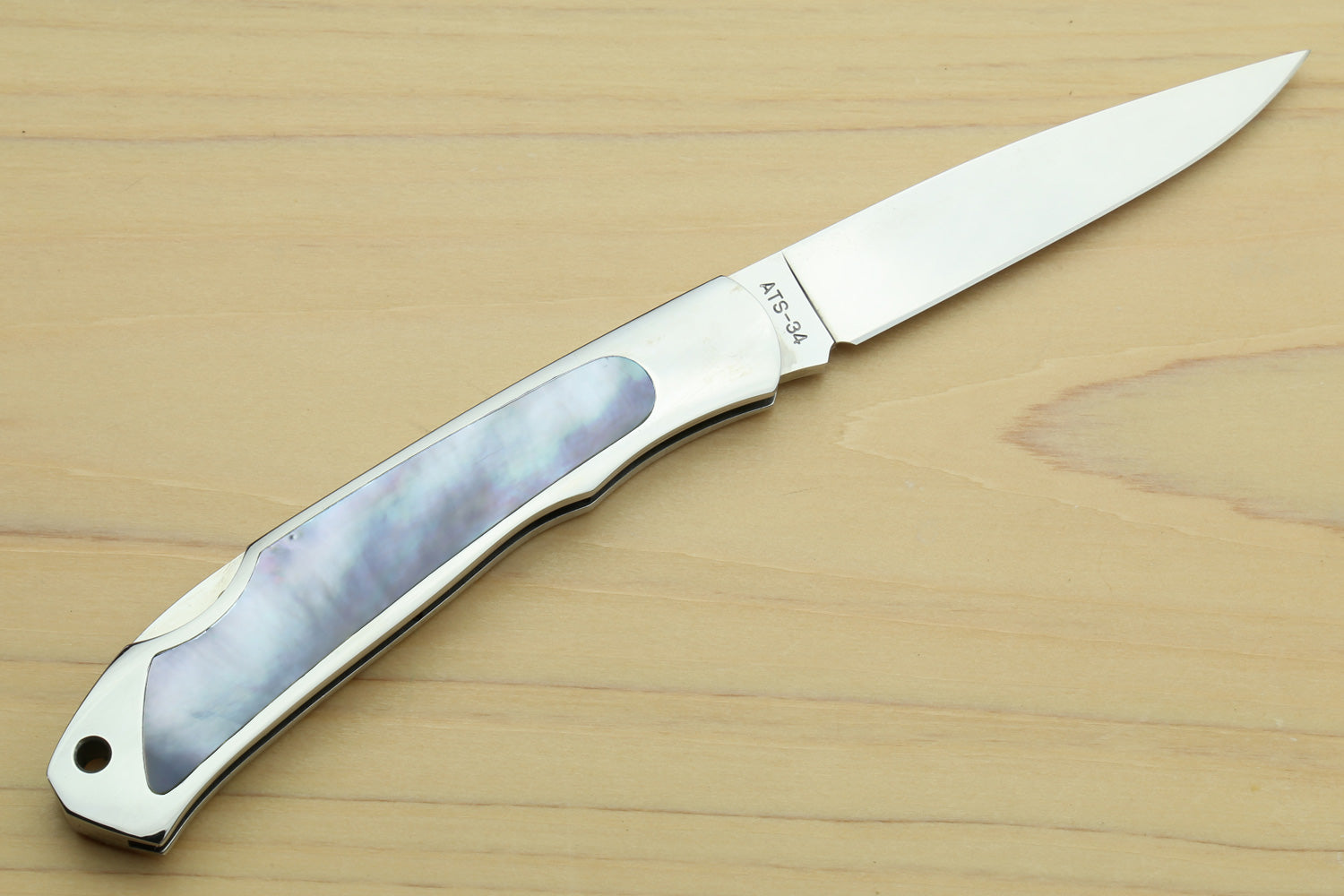 Stainless steel lockback folding pocket knife, open, white handle with abalone inlay