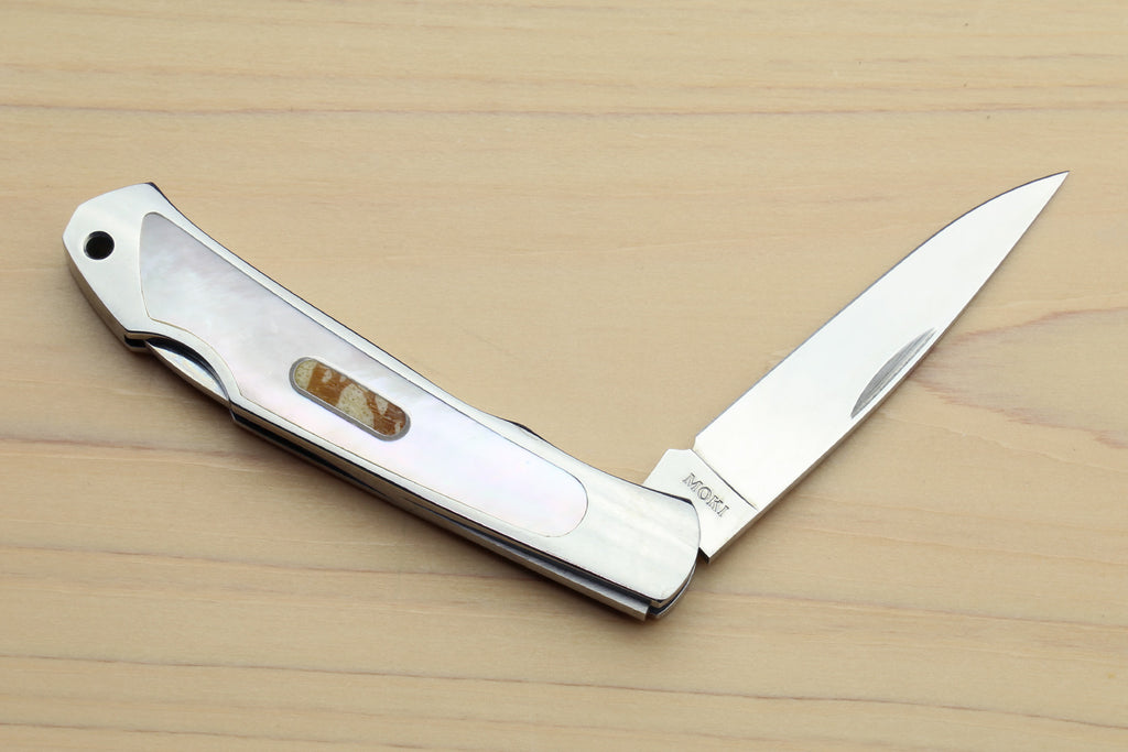 Stainless steel lockback folding pocket knife, partly open, white handle with abalone inlay