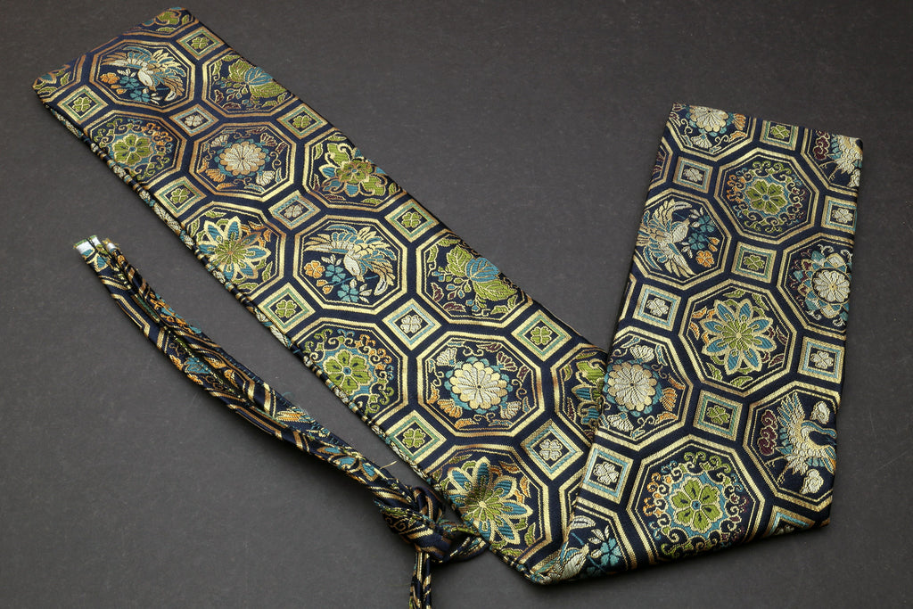 Knife pouch bag with blue-green hexagonal damask print, tied strap and folded pocket