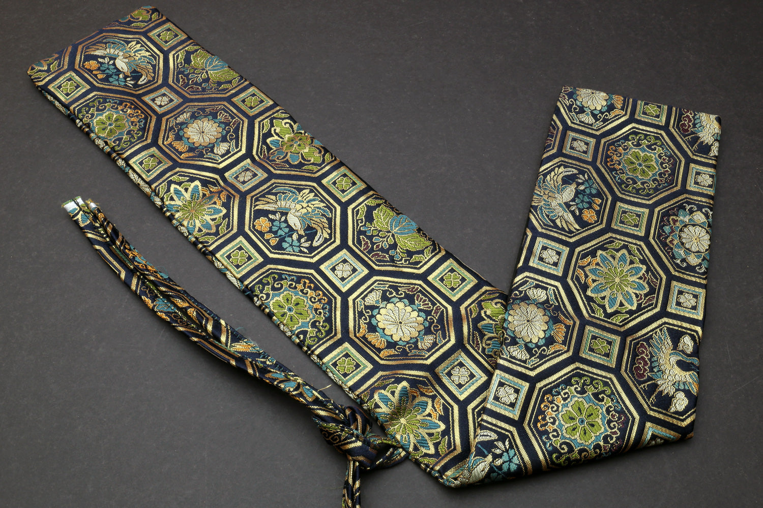 Knife pouch bag with blue-green hexagonal damask print, tied strap and folded pocket