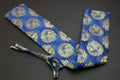 Blue knife pouch with gold dragon pattern, wrapped tie closure and folded fabric