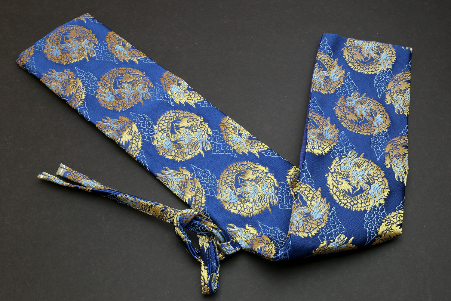 Blue knife pouch with gold dragon pattern, wrapped tie closure and folded fabric