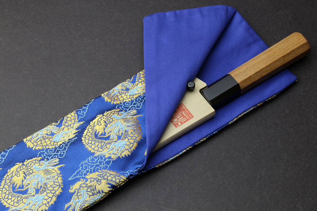 Folded blue knife pouch with gold dragon print, holding a knife with wooden handle