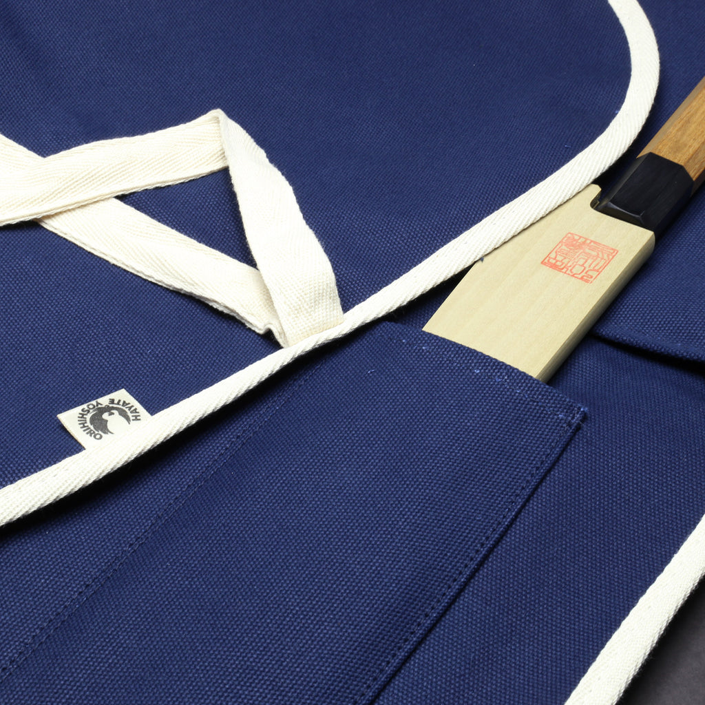 Dark navy knife pouch bag with white drawstring tie and slot pockets visible