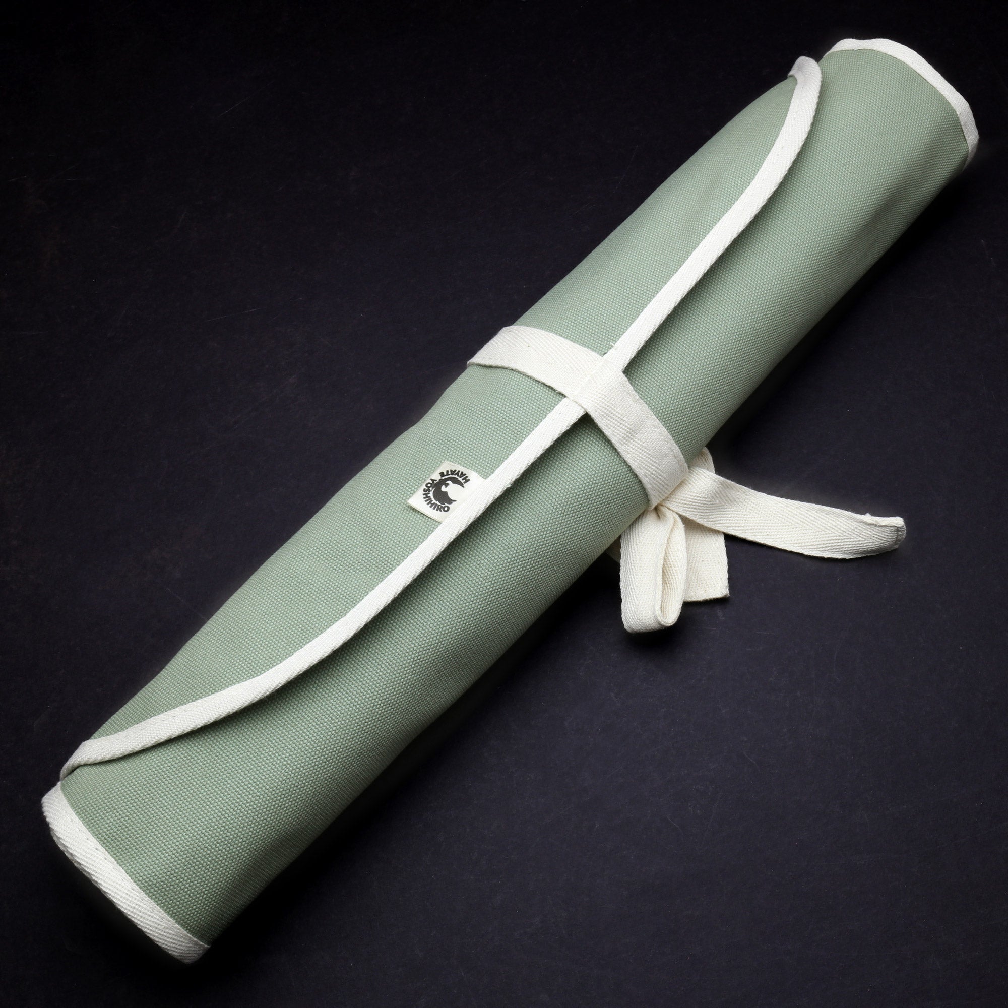 Olive-green cotton 6-slot knife pouch bag, rolled with white carrying strap