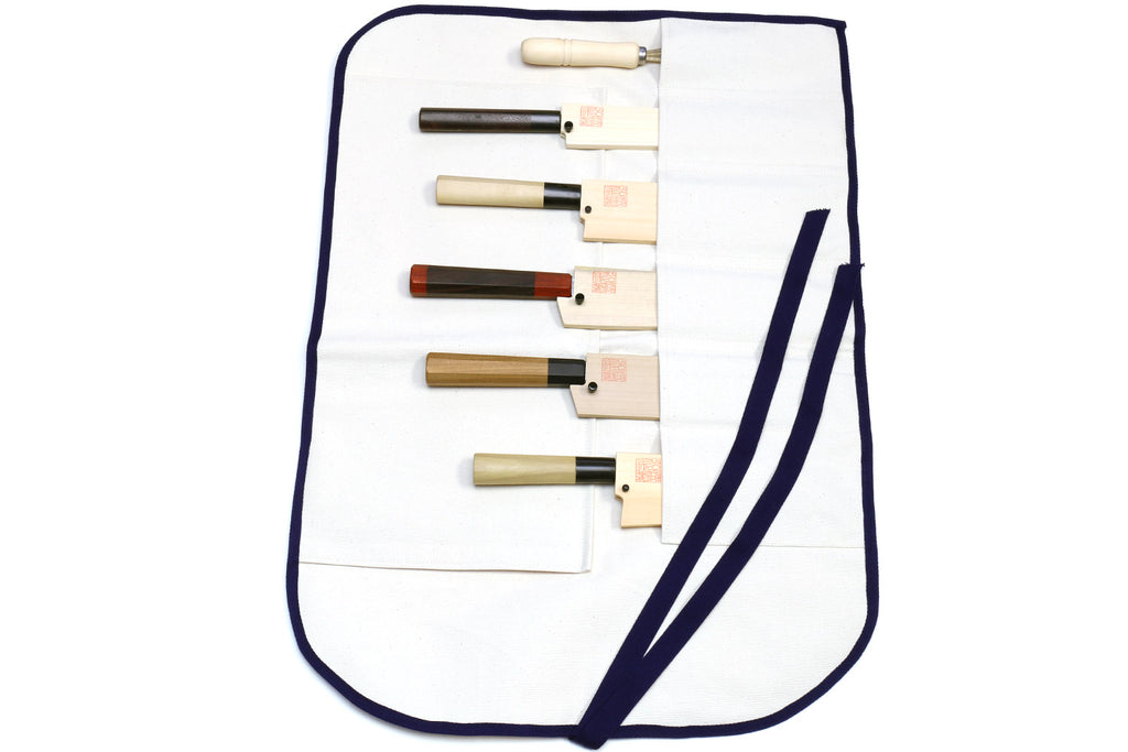 White cotton knife pouch bag with navy trim, holds 6 slots and rolls closed