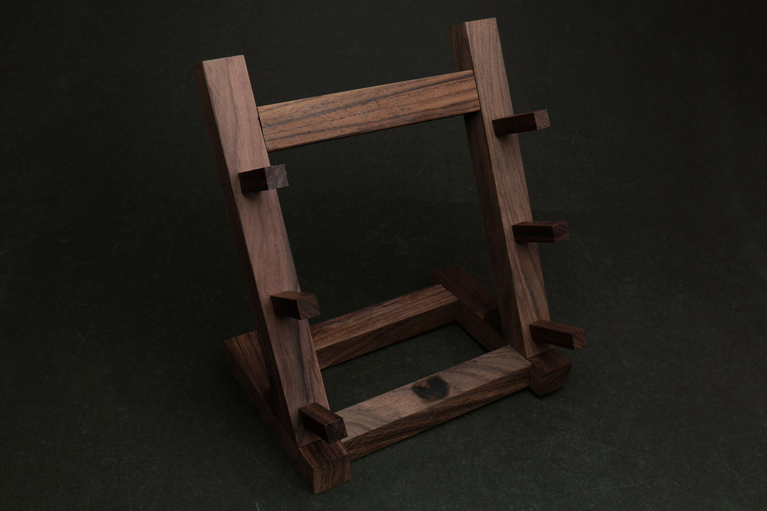 Ebony and rosewood knife rack stand with vertical posts and angled base supports