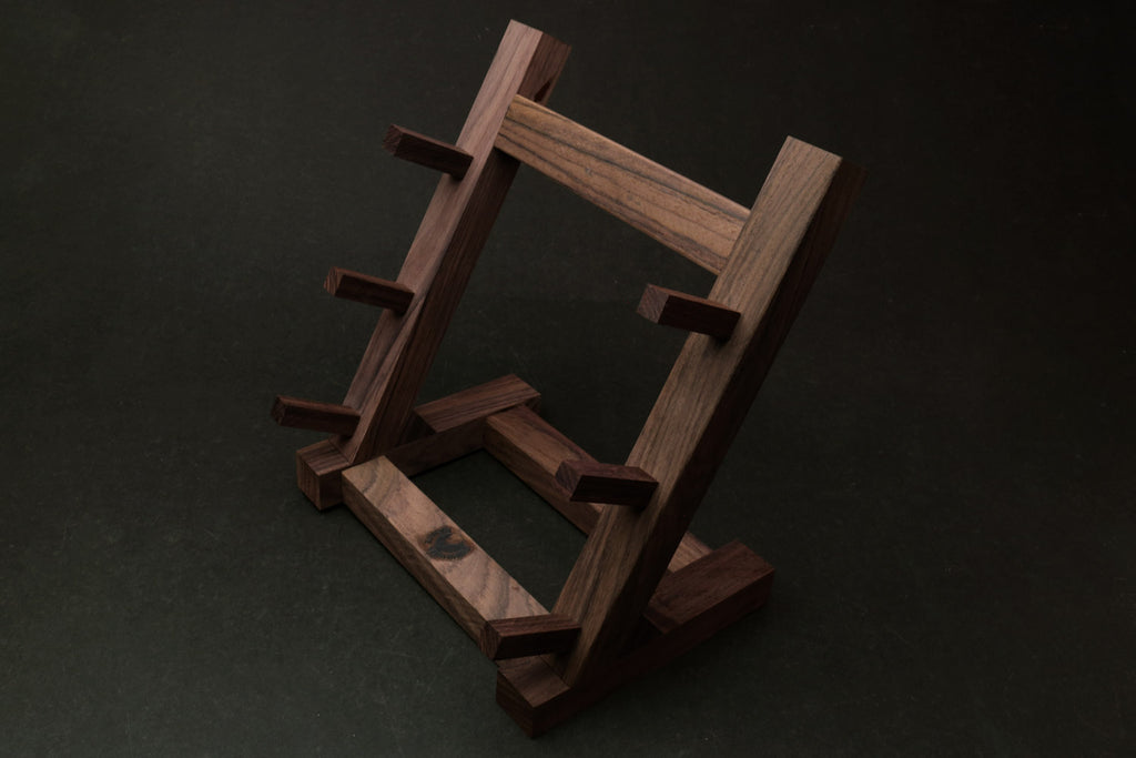 Ebony and rosewood knife rack stand viewed from the side with staggered knife rests