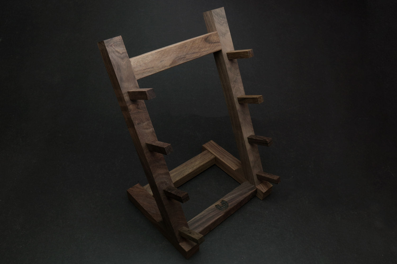 Ebony and rosewood knife rack stand with cutout frame and layered knife holding bars