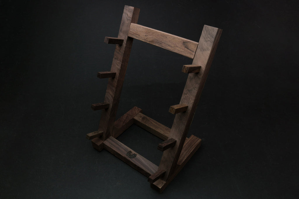 Ebony and rosewood knife rack stand with dark vertical supports and central open base