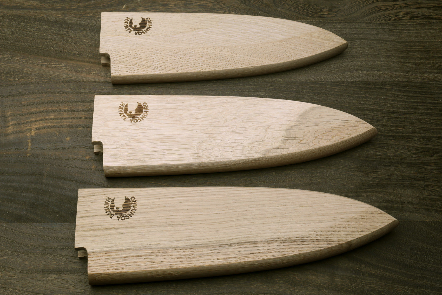 Set of three oak saya blade protectors for deba knives, varying fit openings
