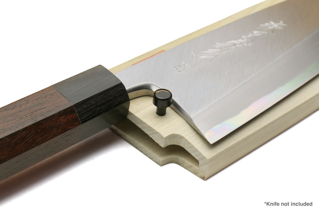 Natural wooden saya knife cover with open slot and black pin; dark knife handle inserted
