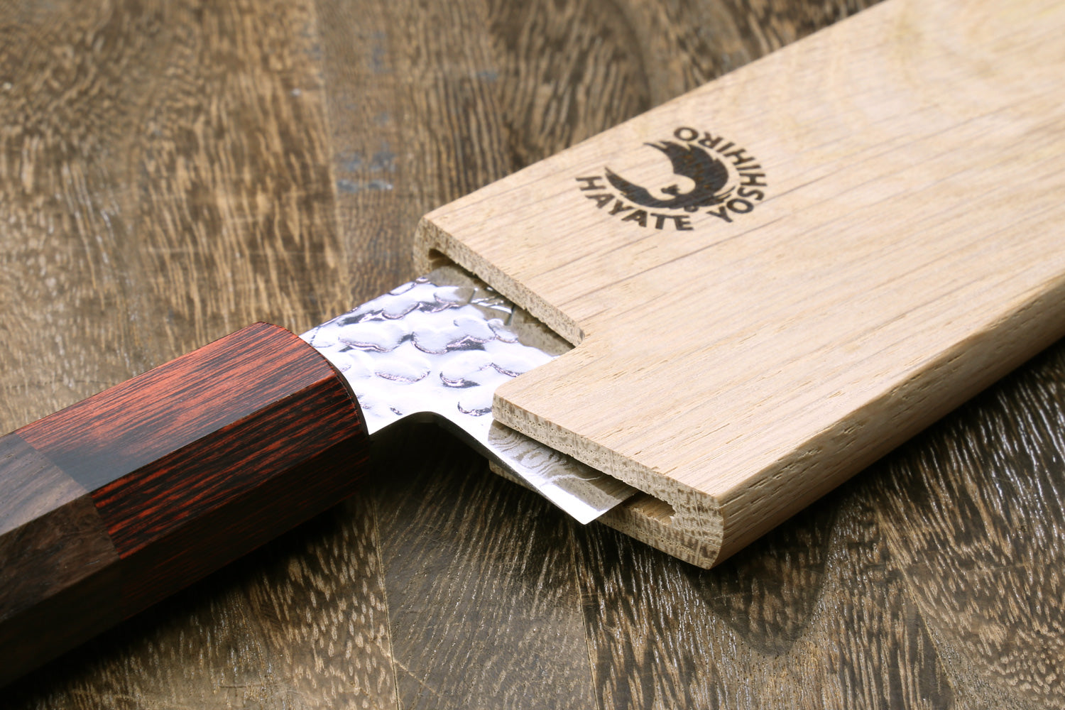 Light oak saya cover with logo, fold-over top with blade partially inserted