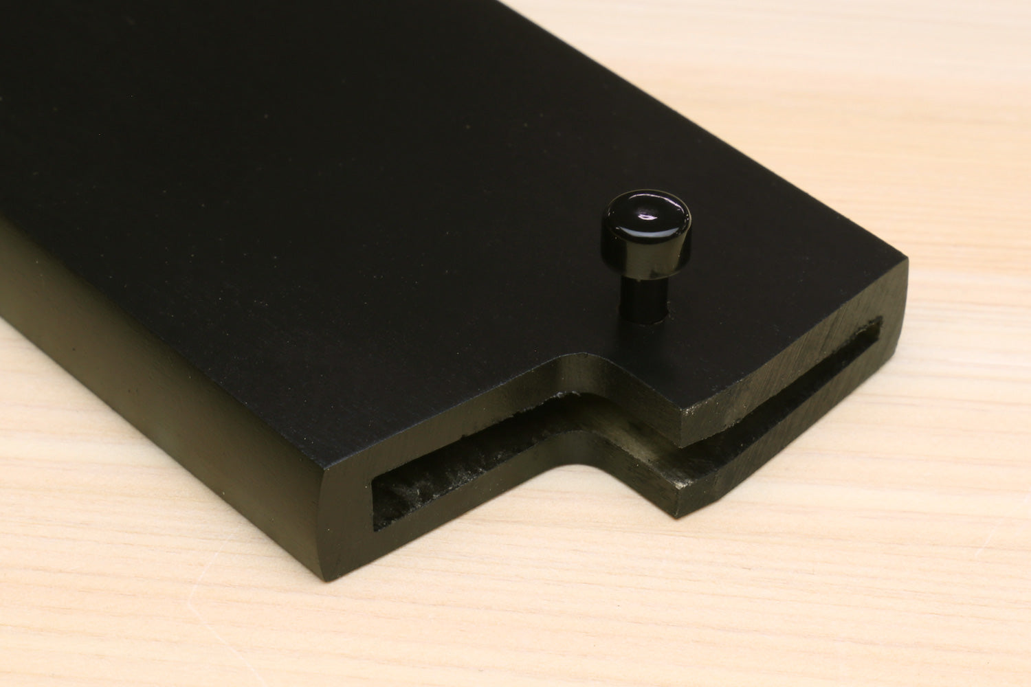 Dark lacquered wooden saya cover with corner notch and round fastening knob