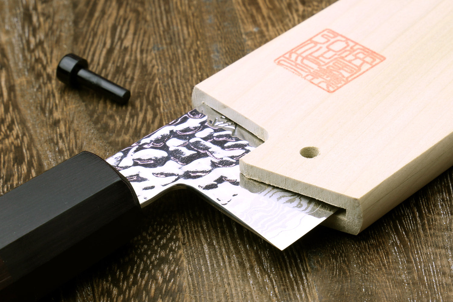 Wooden saya blade protector cover with cutout slot and stamped emblem