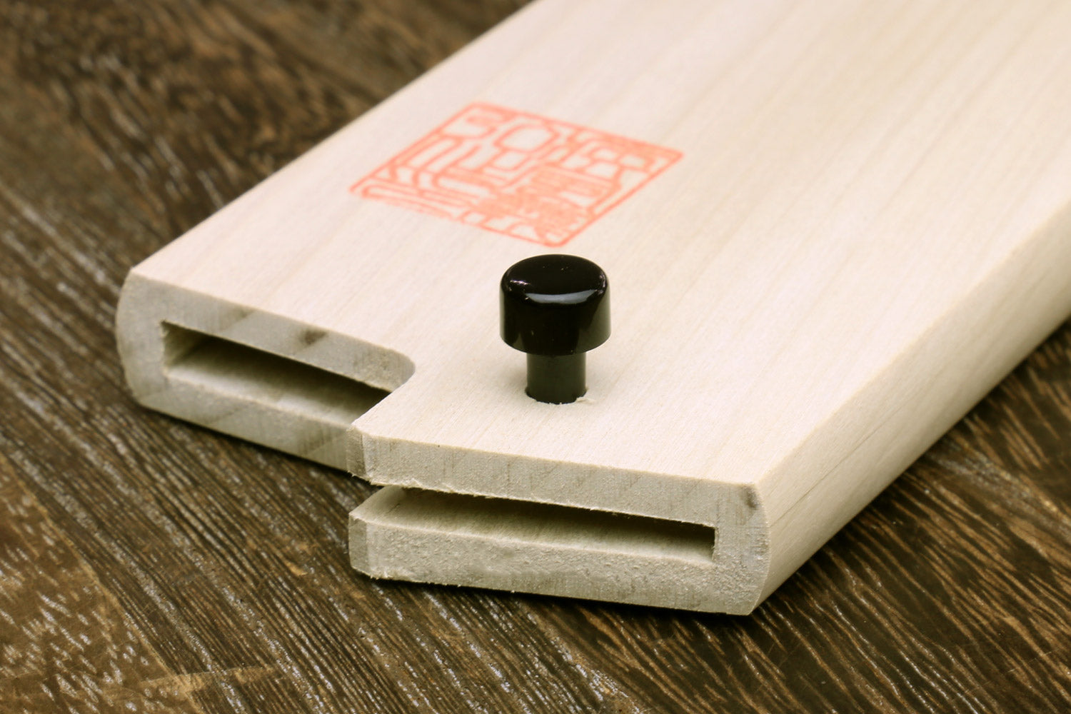 Light wood wooden blade protector saya with recessed slots and black knob