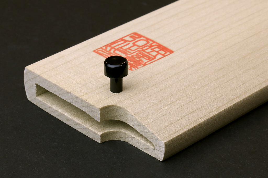 Wooden saya cover with open mouth and black rivet, pale natural magnolia