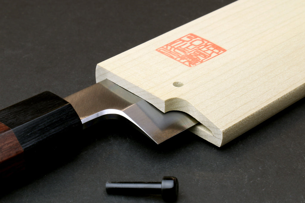 Wooden saya cover with open slot, red stamp label, pale natural magnolia
