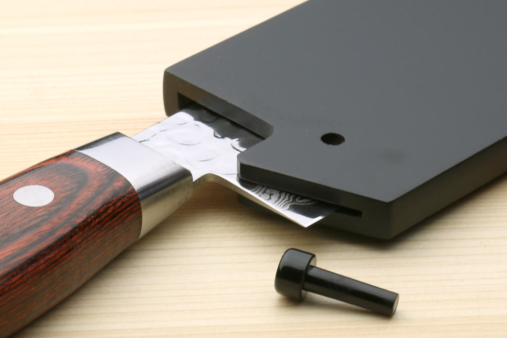 Lacquered wooden knife saya cover holding a thin-blade kitchen knife