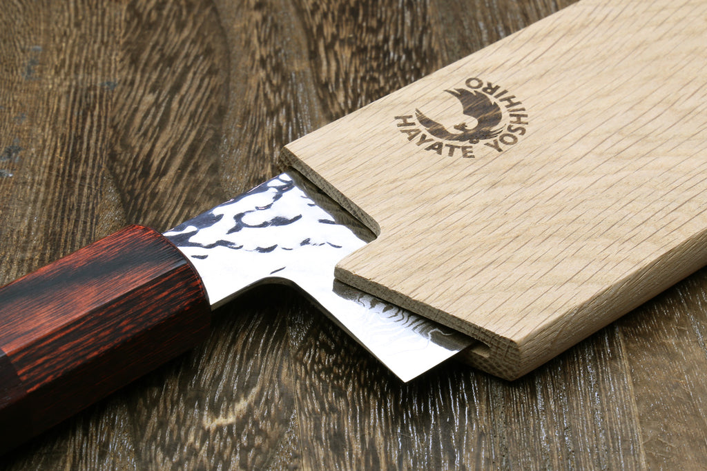 Oak wood saya blade cover with interior slot holding a knife blade