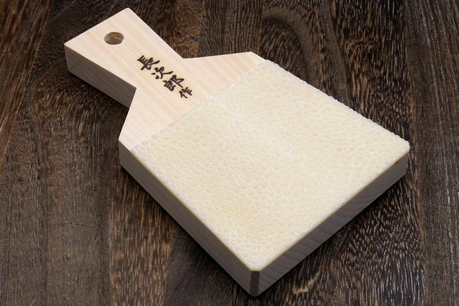 Japanese sharkskin grater block with light wood handle and white textured surface
