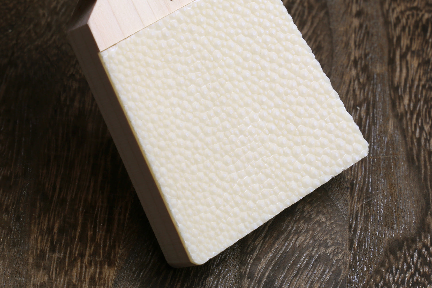 Japanese sharkskin grater block with white textured grating face and light wood base