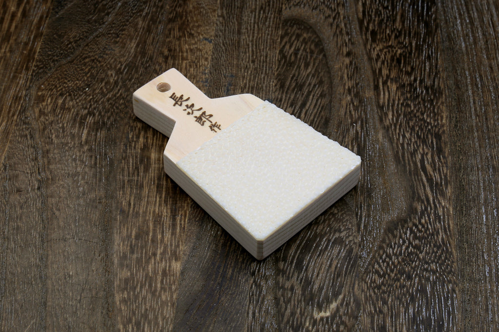 Japanese sharkskin grater block with white textured face and light wood handle