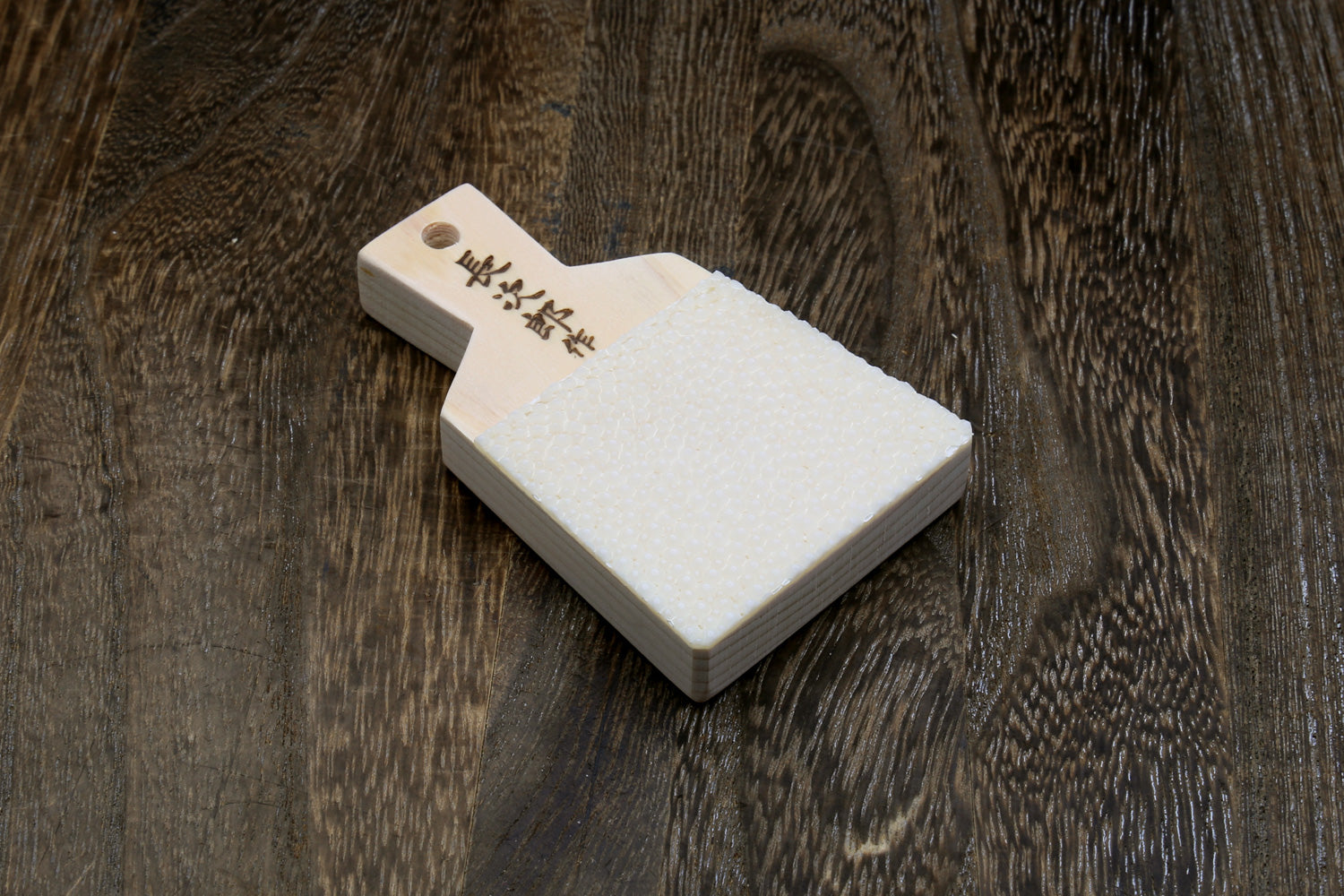 Japanese sharkskin grater block with white textured face and light wood handle
