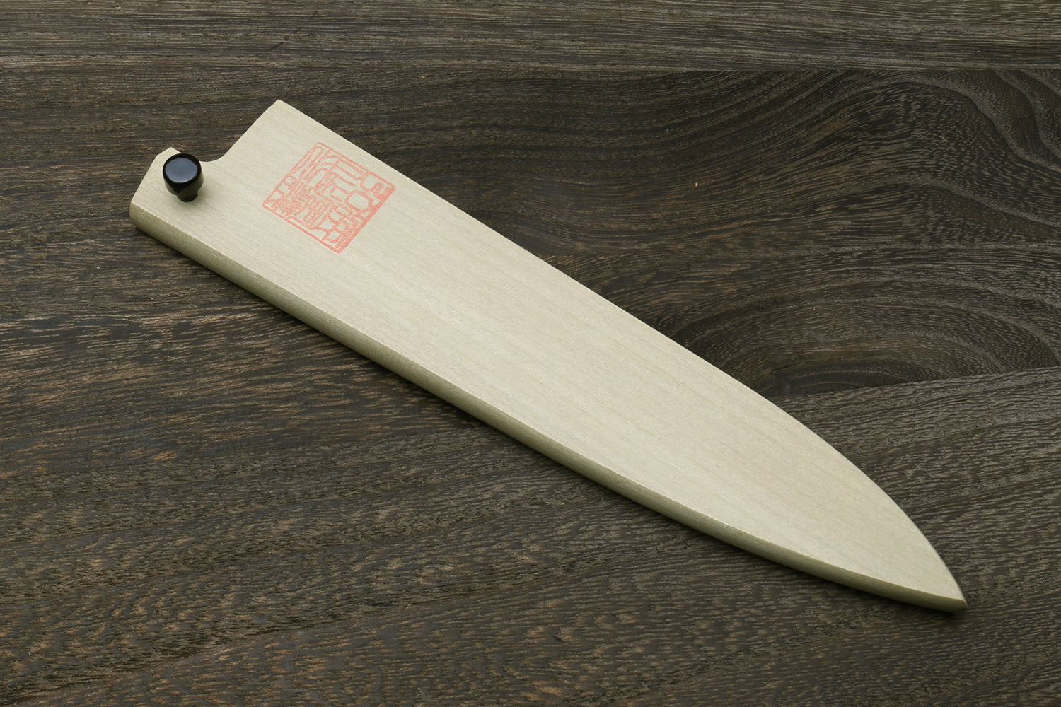 Petty knife blade protector in natural magnolia wood with black end cap and stamp.