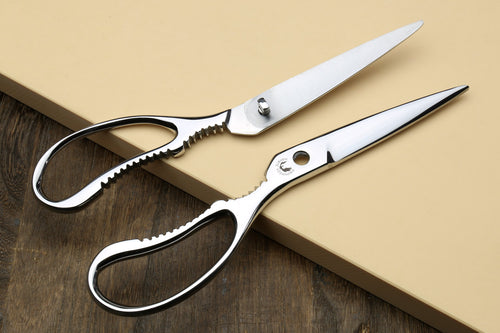 Stainless kitchen shears with white handle, scalloped lower blade and finger loops