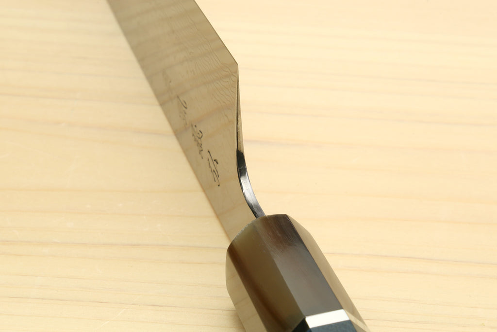 Chef knife handle and bolster close-up with ocean blue inset and rivet