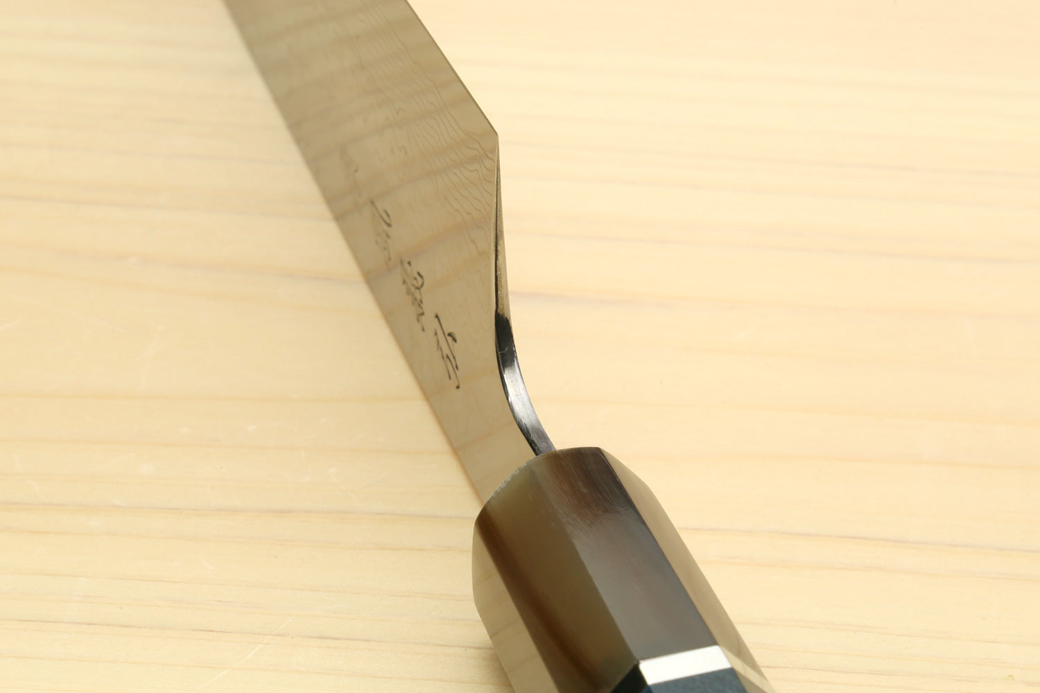 Chef knife handle and bolster close-up with ocean blue inset and rivet