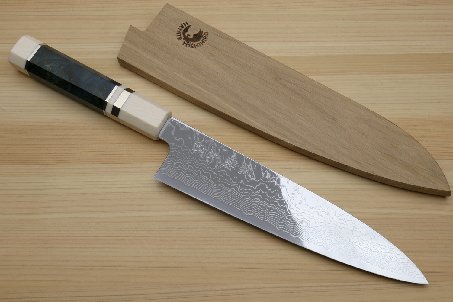 Damascus gyuto chef knife with ocean blue handle, ivory bolster, and patterned steel blade