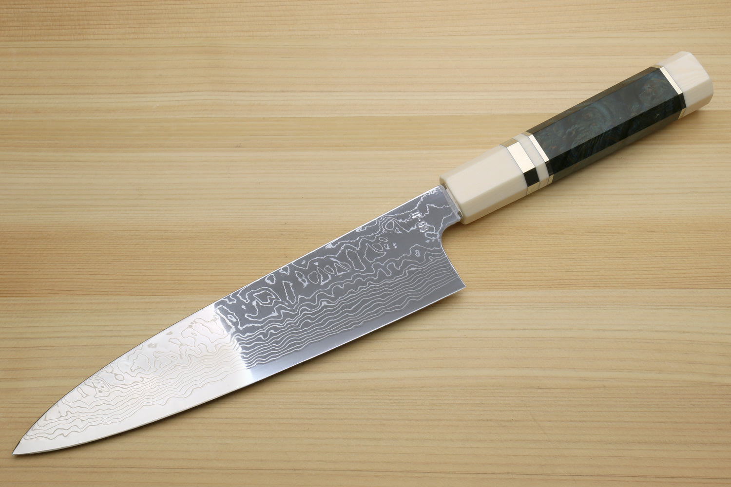 Damascus gyuto chef knife with ocean blue handle and white-patterned steel blade
