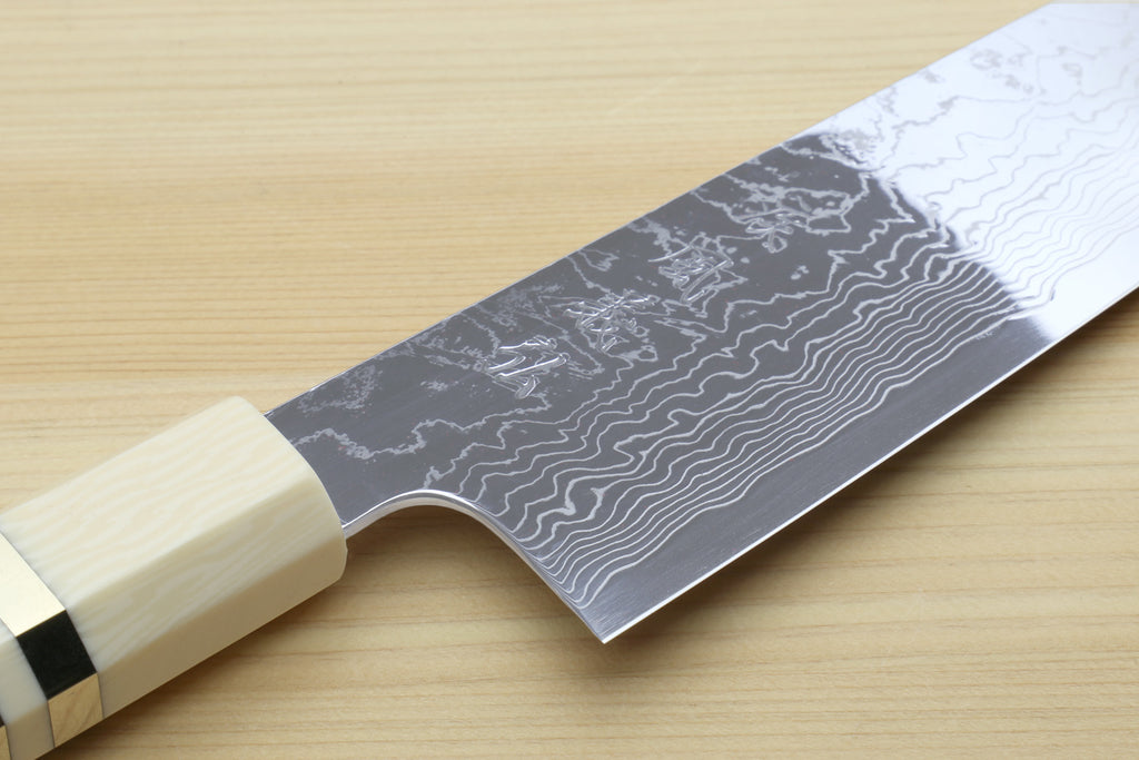 Damascus gyuto chef knife close view of patterned blade and ivory bolster