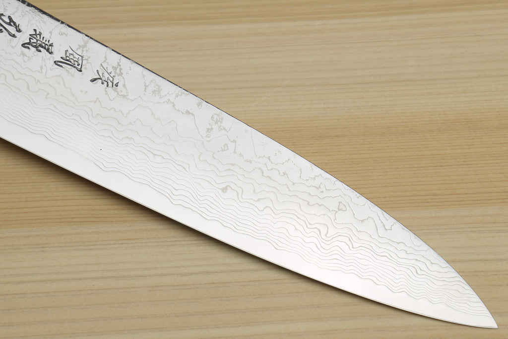 Damascus gyuto chef knife blade with flowing pattern along the edge